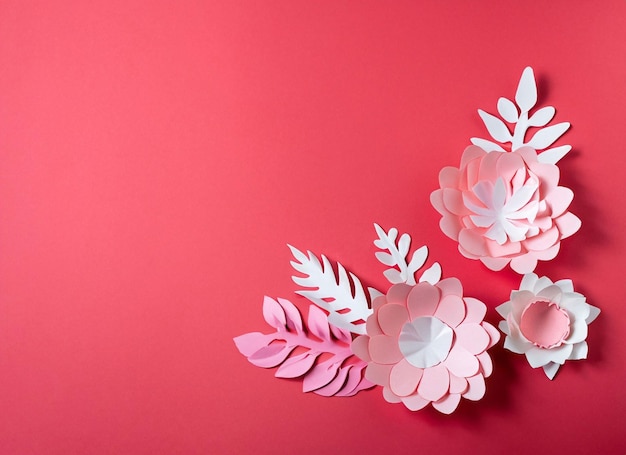 Paper flowers on a red background with the word love on it.