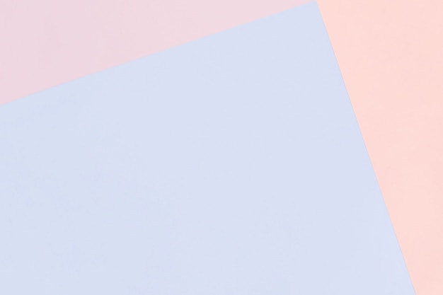 Paper geometric pastel background in pink and blue colors with copy space.