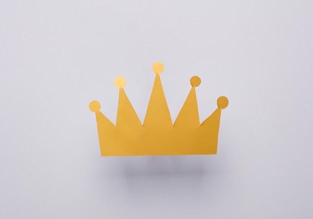 paper golden crown on gray background