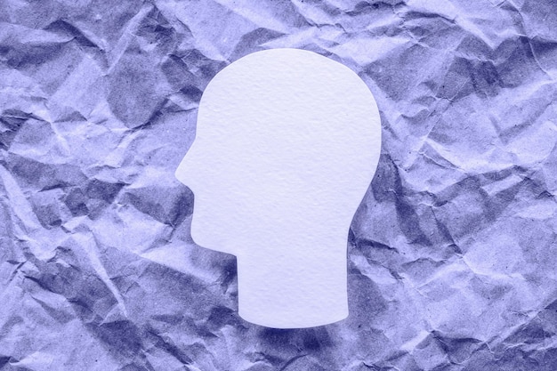 Paper head on purple background, mental health and psychology