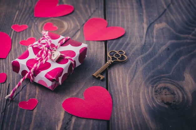 Paper heart and gift box on the old wood table background. Valentine's day concept