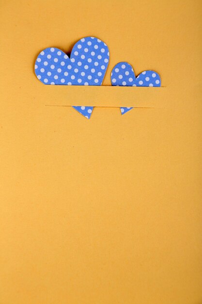 Paper hearts on beige background, close up