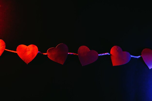 Paper hearts on black background