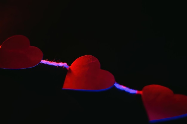 Paper hearts on black background