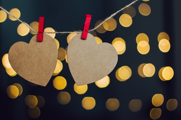 paper hearts hanging with an unfocused background