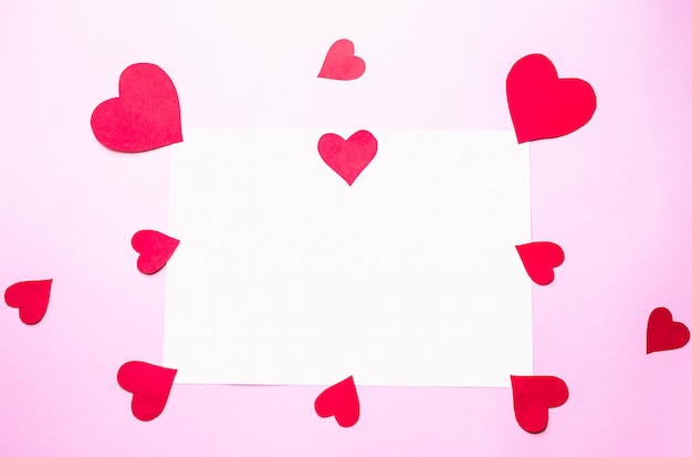 Paper hearts on a pink background Valentine's Day concept