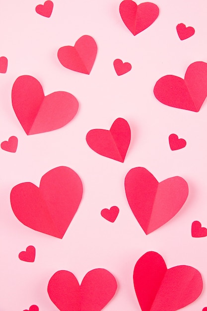 Paper hearts over the pink pastel background