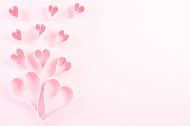 Paper hearts on pink pastel paper