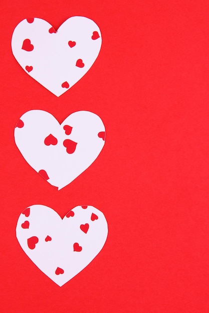 Paper hearts on red background