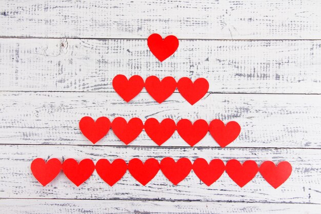 Paper hearts on wooden background