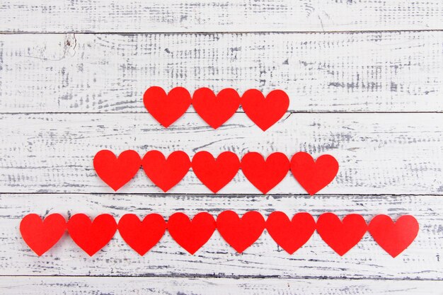 Paper hearts on wooden background