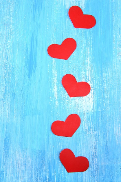 Paper hearts on wooden background