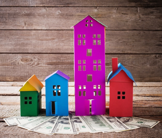 paper houses stands over wooden wall