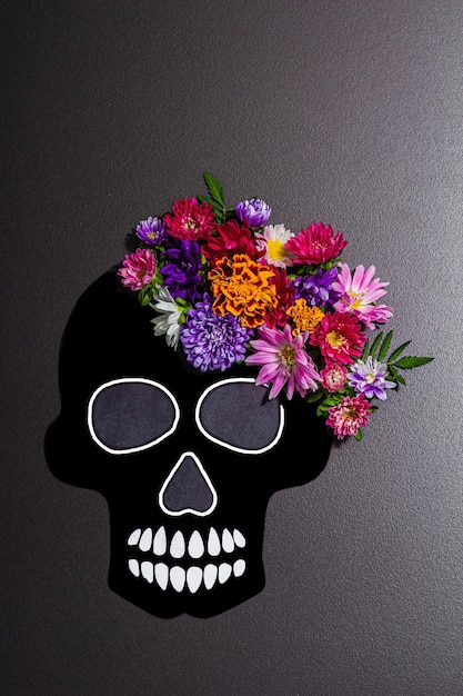 Paper human skull for Mexico39s Day of the Dead El Dia de Muertos with traditional flowers