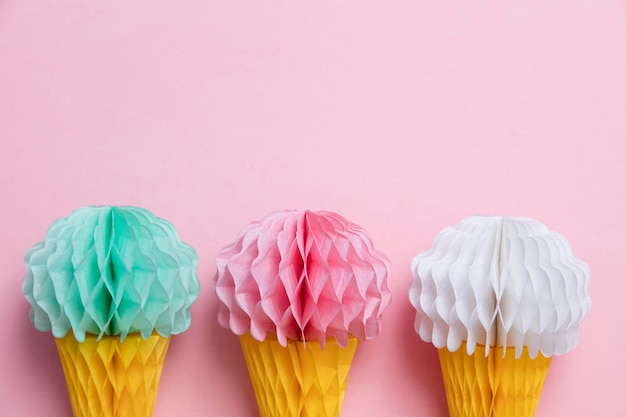 Paper ice cream cone decoration on a pastel pink background