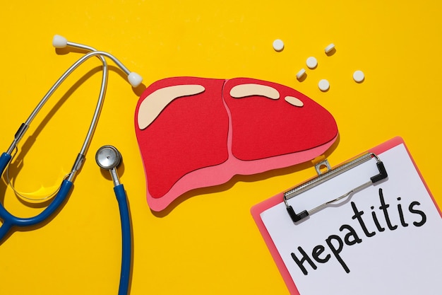 Photo paper liver mockup stethoscope and folder on yellow background top view