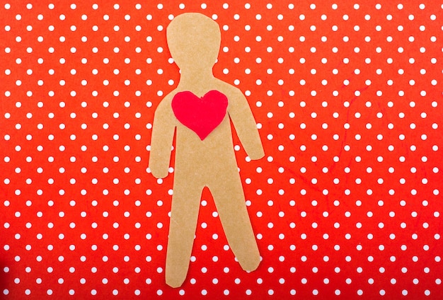 Paper man and a heart shape cut out of paper
