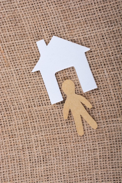 Paper man shape beside a house shape in view