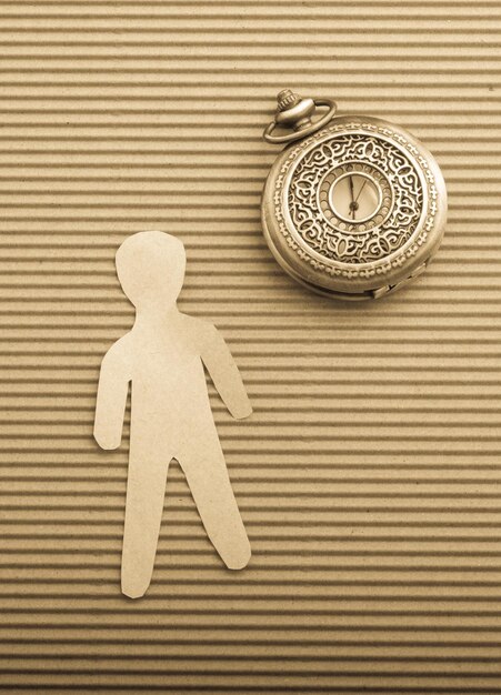 Photo paper man shape and a pocket watch