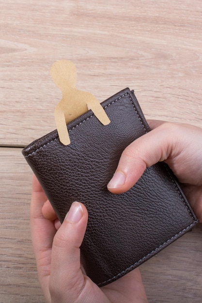 Paper man shape in wallet in hand