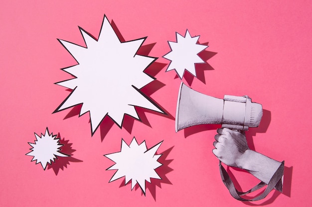 paper megaphone and speech bubbles arrangement