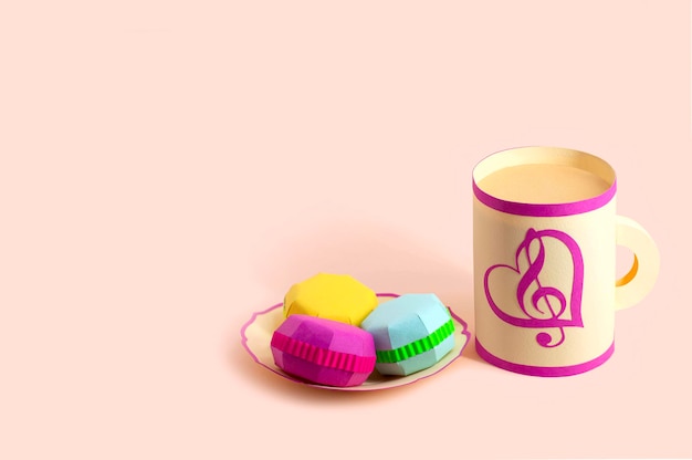 Paper mug and plate with multicolored macaroons