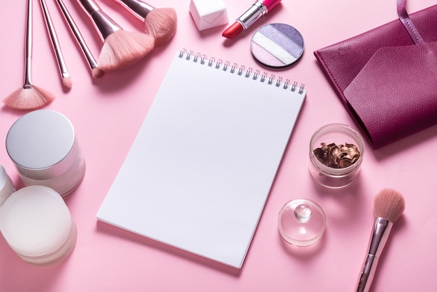 Paper notebook flat lay mock up on pink cosmetic table