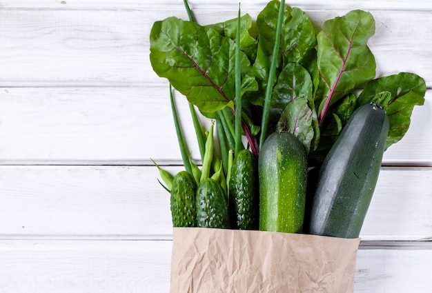 Paper package filled with fresh green vegetables