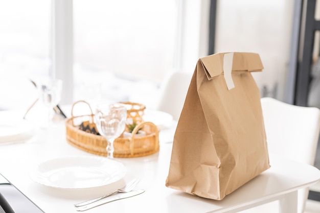 Paper packages with groceries on kitchen table.