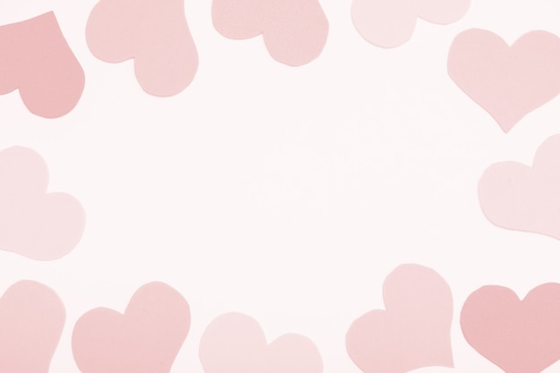 Paper pink background, frame from hearts, copy space.