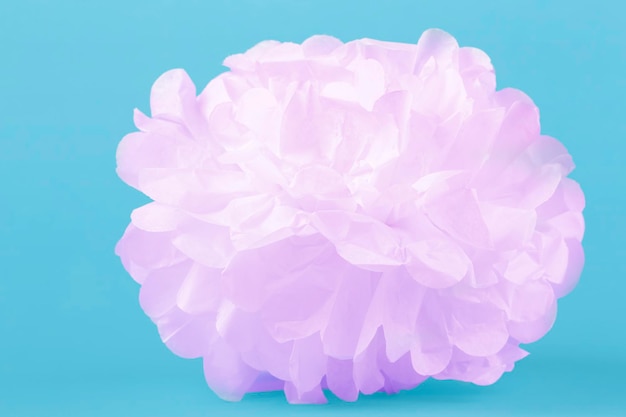 Paper pink flower on a blue background