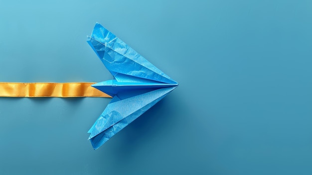 Photo a paper plane adorned with a blue ribbon representing autism awareness