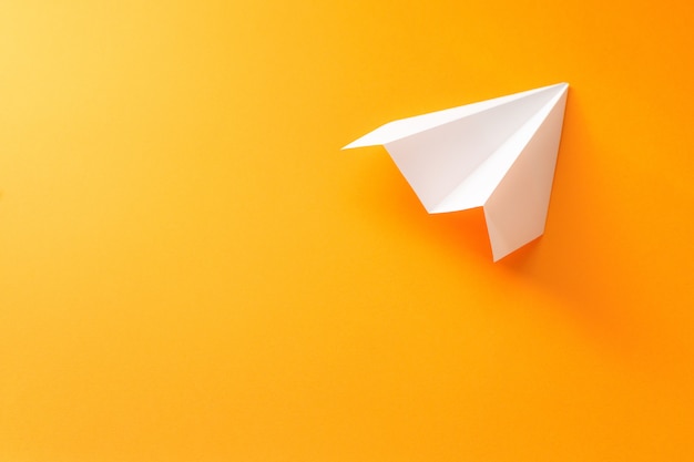 paper plane on an orange background