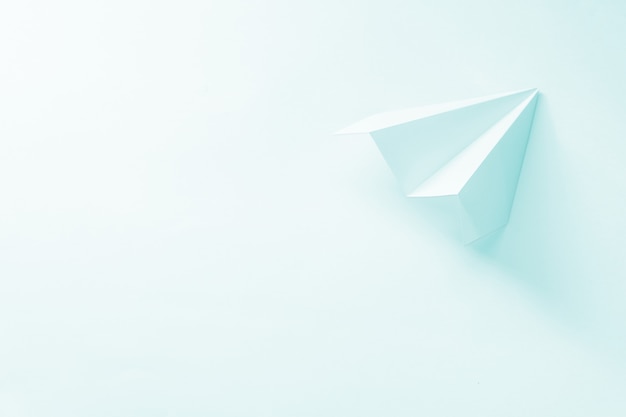 paper plane on pale blue.