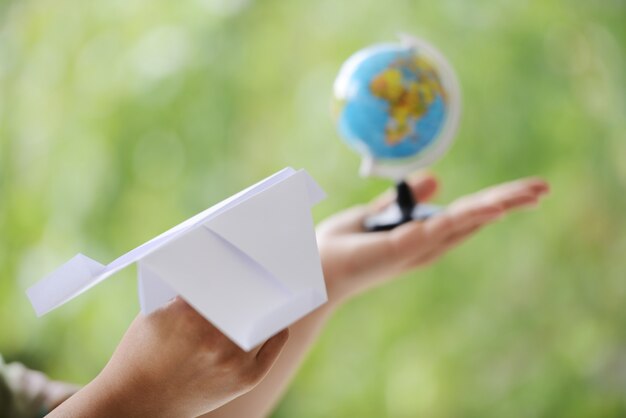 Paper plane traveling to globe world