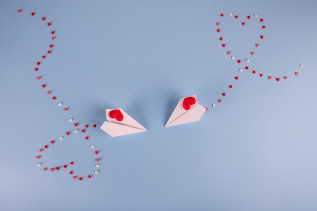 Photo paper planes flying with heart candies