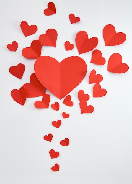 Paper red hearts on white background