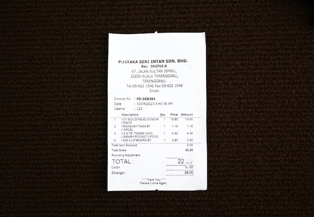 Photo paper sales receipt isolated on a dark background proof of purchase concept