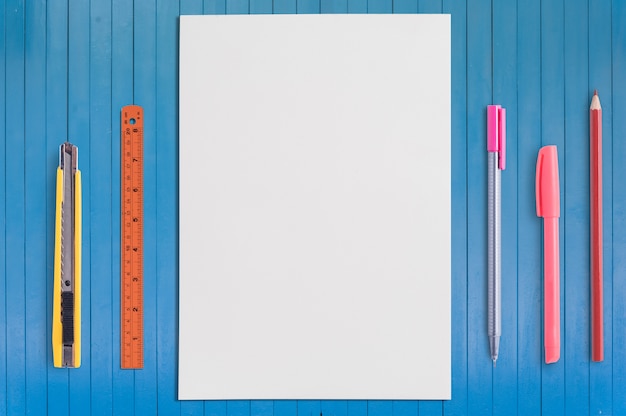 Paper and school  tools on wood background