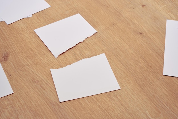 Paper scraps. Ripped papers, torn page on a wooden table. 