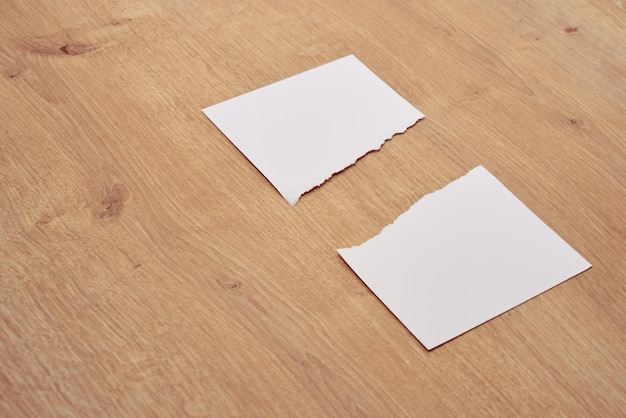 Paper scraps. Ripped papers, torn page on a wooden table. 