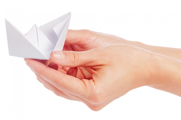 Paper ship in a female hand