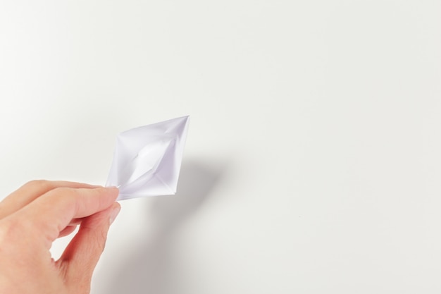 Paper ship in a female hand