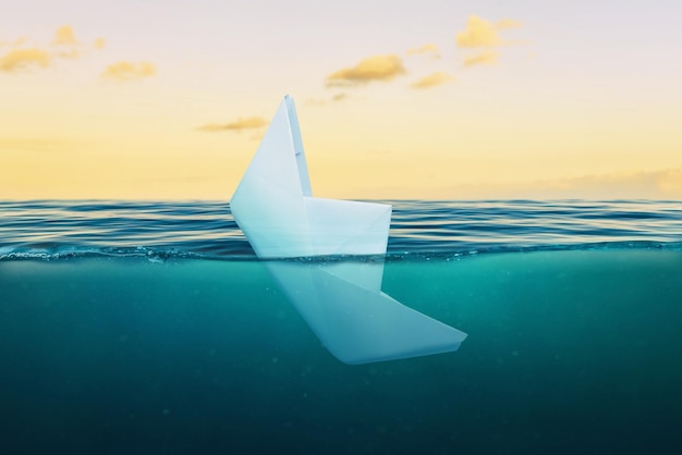 A paper ship sinking into the sea The concept of failure in business and private life