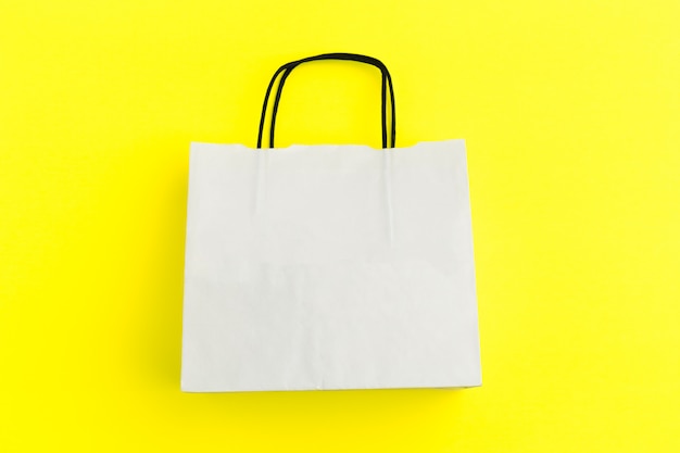 Paper shopping bag on colorful background