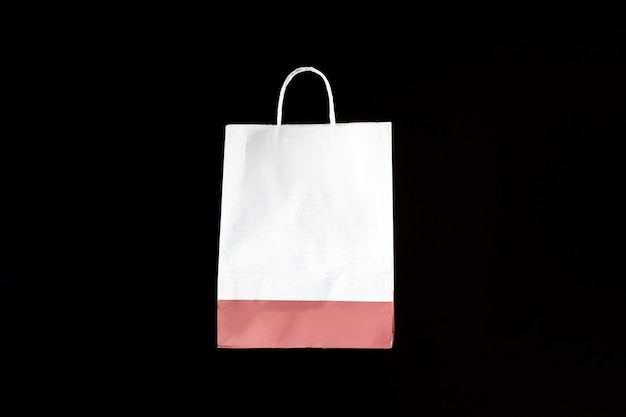 Paper shopping bag levitating against the dark wall