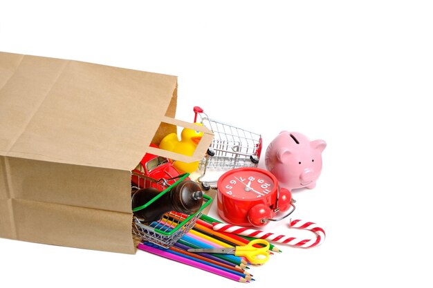 Paper shopping bag and a scattering household goods white background