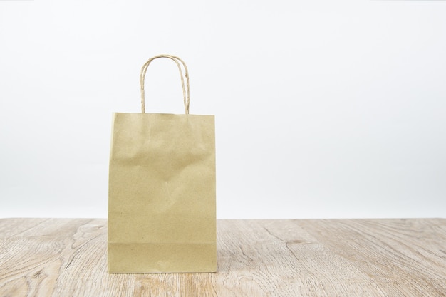 Paper shopping bag on wooden floor