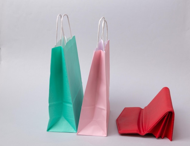 Paper shopping bags and purse on white background Shopping concept