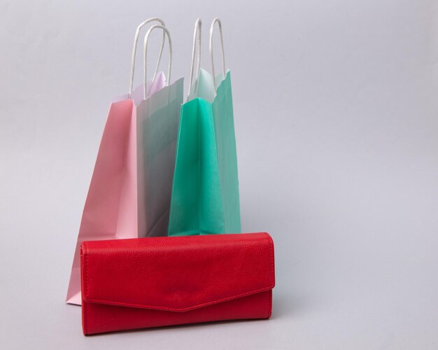 Paper shopping bags and purse on white background shopping\
concept